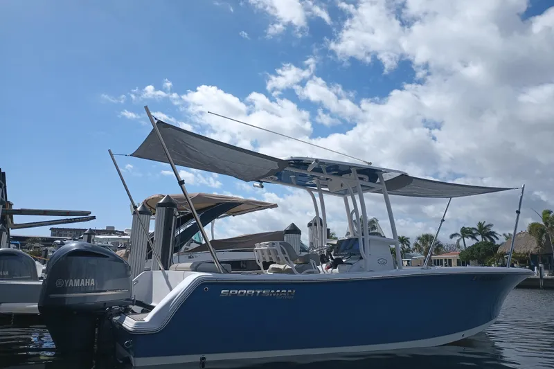 Slide: The Image of 2023 Sportsman Heritage 231 Center Console boat docked under a partly cloudy sky. - 37