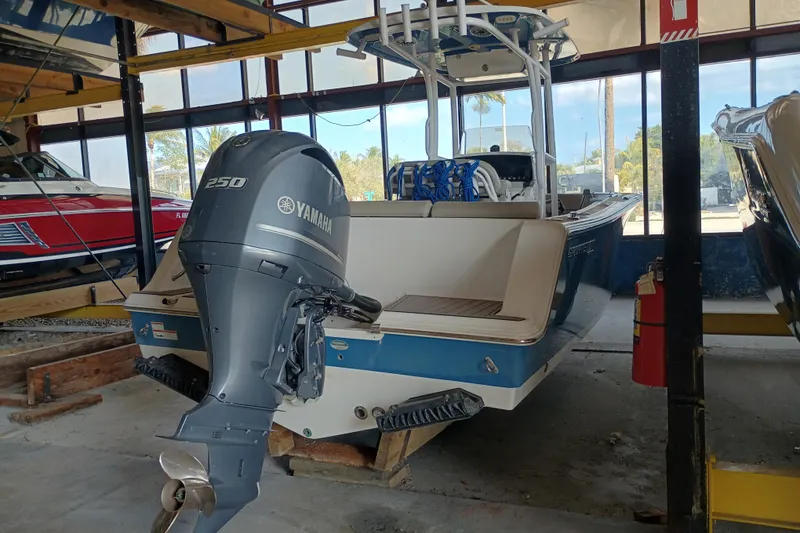 Slide: The Image of 2023 Sportsman Heritage 231 Center Console boat with Yamaha 250 engine in storage. - 4