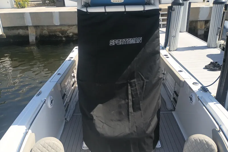 Slide: The Image of 2023 Sportsman Heritage 231 Center Console boat docked, featuring covered console area. - 40