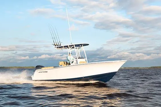 Slide: The Image of 2023 Sportsman Heritage 231 Center Console boat, blue T-top with speakers and rod holders. - 6