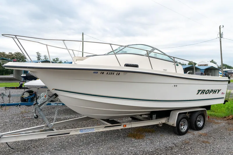 The Image of 2002 Bayliner 2302 Trophy Walkaround boat on trailer, parked outdoors. - 1