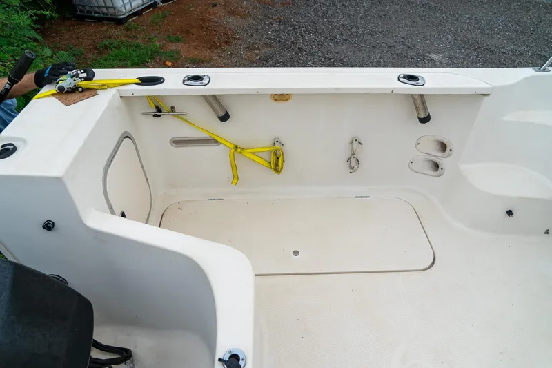 Slide: The Image of 2002 Bayliner 2302 Trophy Walkaround boat interior with storage and fishing rod holders. - 12