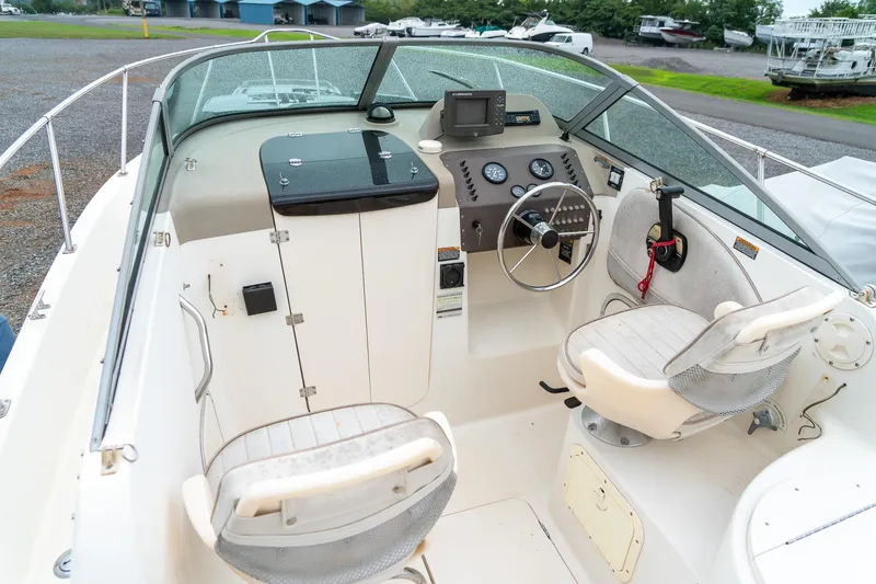 Slide: The Image of 2002 Bayliner 2302 Trophy Walkaround boat interior with steering wheel and seating. - 14