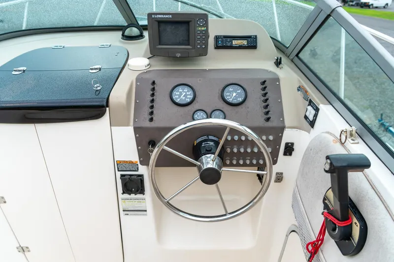 Slide: The Image of Helm of 2002 Bayliner 2302 Trophy Walkaround with steering wheel and navigation instruments. - 16