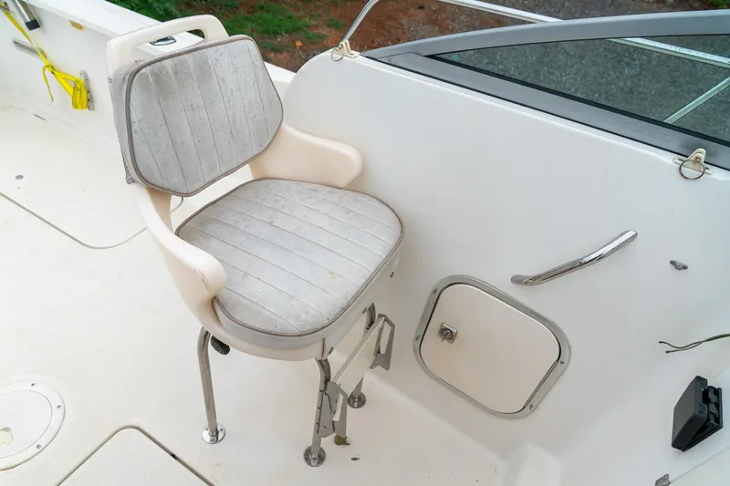 Slide: The Image of Captain's chair on 2002 Bayliner 2302 Trophy Walkaround boat deck, near storage compartment. - 18