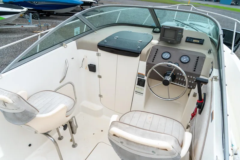 Slide: The Image of 2002 Bayliner 2302 Trophy Walkaround boat cockpit with steering wheel and seating. - 19