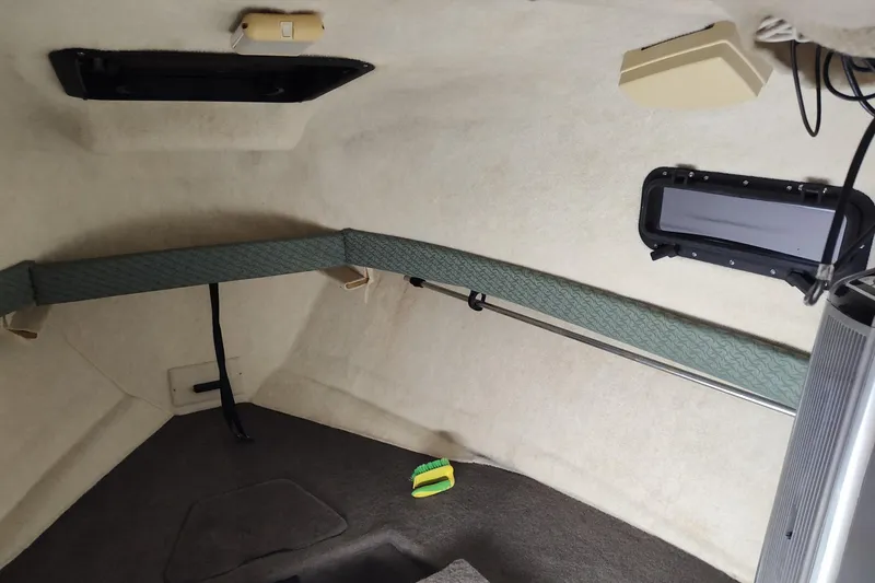 Slide: The Image of Interior cabin of 2002 Bayliner 2302 Trophy Walkaround boat, featuring compact design and window. - 26