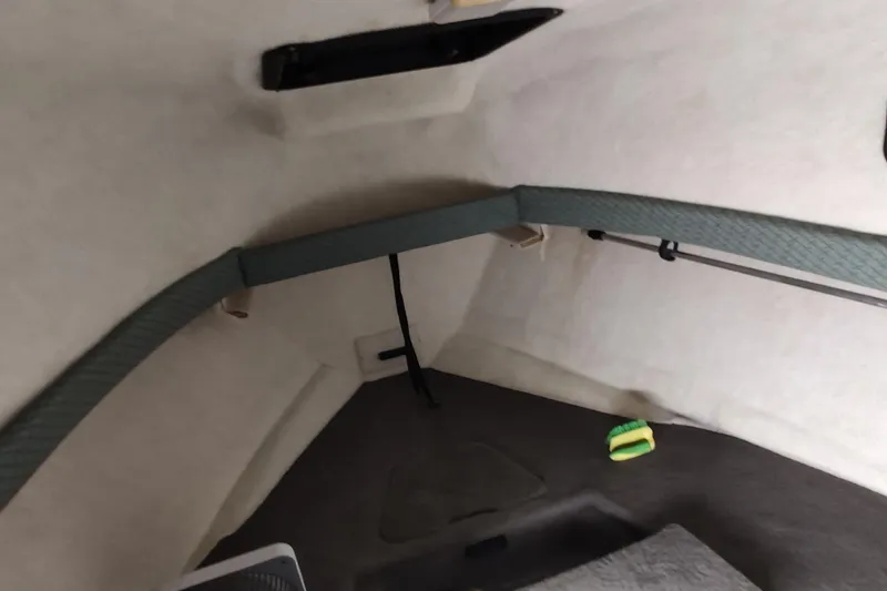 Slide: The Image of Interior cabin of 2002 Bayliner 2302 Trophy Walkaround boat, featuring storage and seating area. - 27