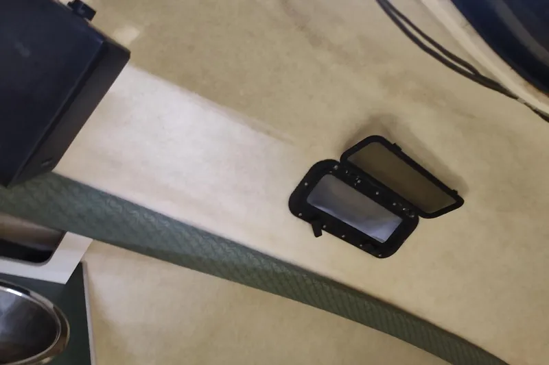 Slide: The Image of 2002 Bayliner 2302 Trophy Walkaround cabin interior with open hatch window. - 28