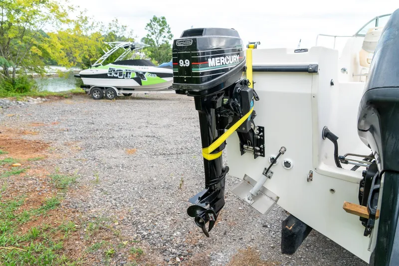 Slide: The Image of 2002 Bayliner 2302 Trophy Walkaround with Mercury outboard motor, parked near a lake. - 6