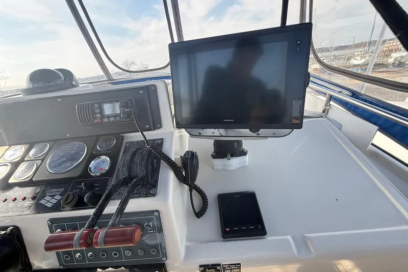 Slide: The Image of Control panel of a 1990 Silverton 37 Convertible boat with navigation equipment. - 11