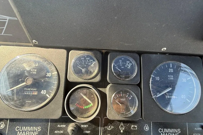 Slide: The Image of 1990 Silverton 37 Convertible dashboard with Cummins Marine gauges and RPM indicators. - 13