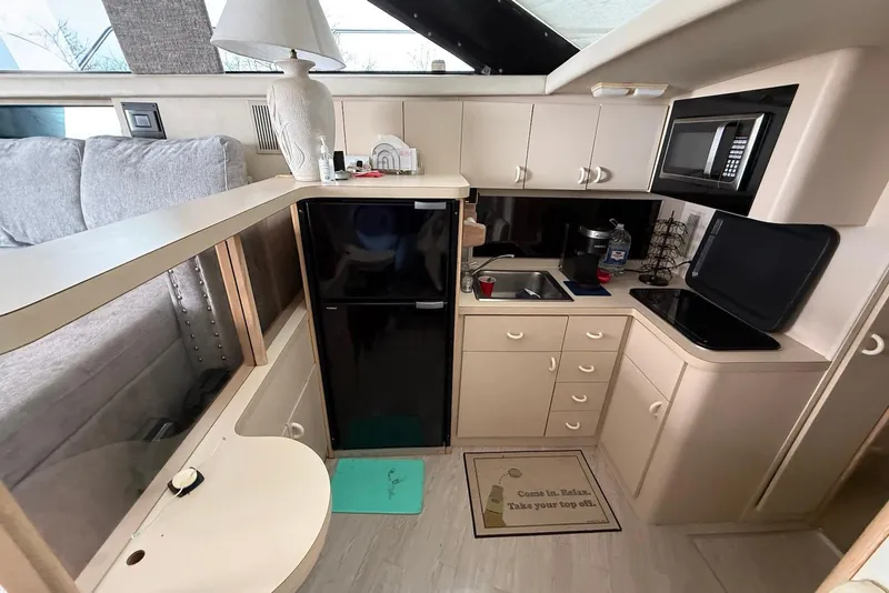 Slide: The Image of 1990 Silverton 37 Convertible yacht interior kitchen with appliances and cabinetry. - 22
