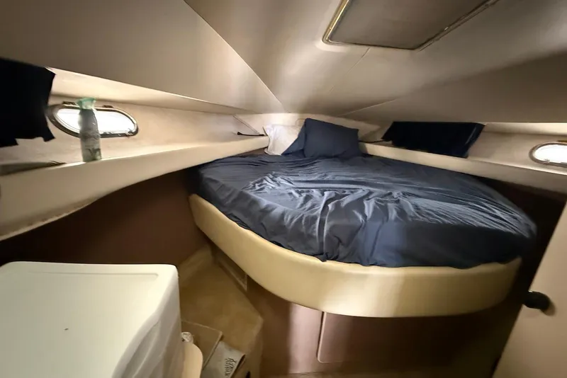 Slide: The Image of Cozy cabin interior of 1990 Silverton 37 Convertible with round bed and portholes. - 24
