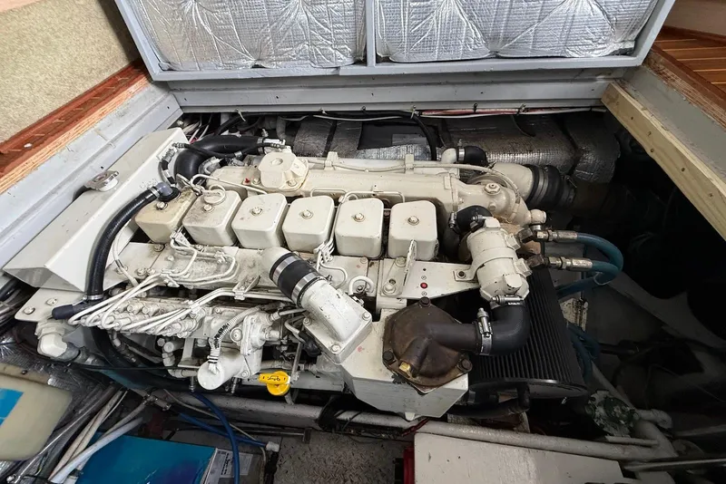 Slide: The Image of Engine compartment of a 1990 Silverton 37 Convertible boat, showcasing detailed machinery. - 28