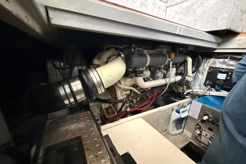 Slide: The Image of Engine room of a 1990 Silverton 37 Convertible boat, showcasing mechanical components. - 30