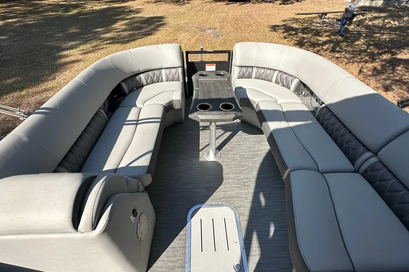 Slide: The Image of 2023 Bennington LX 26 Swingback boat interior with spacious seating and table. - 15