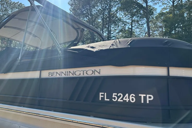 Slide: The Image of 2023 Bennington LX 26 Swingback boat with canopy, sunlight streaming, and registration number FL 5246 TP. - 17
