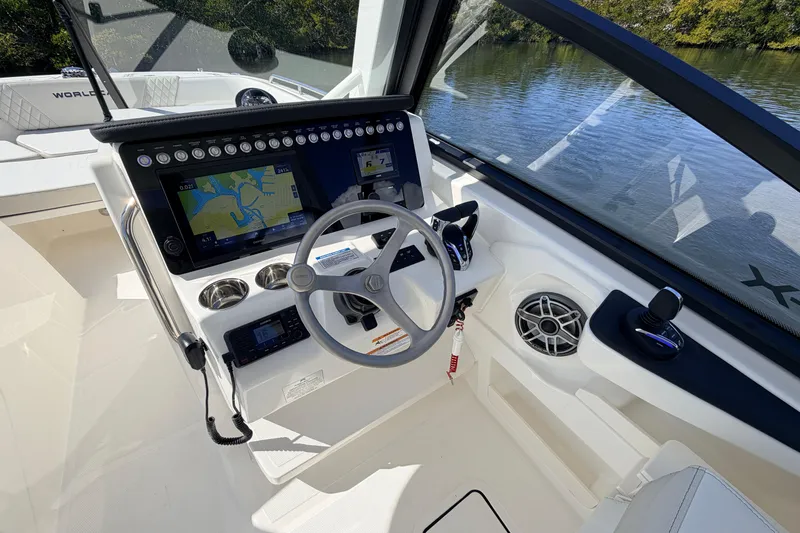 Slide: The Image of 2026 World Cat 265 DC-X boat cockpit with modern navigation system and steering wheel. - 11