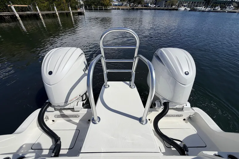 Slide: The Image of 2026 World Cat 265 DC-X boat with dual Yamaha outboard engines on a calm waterway. - 7