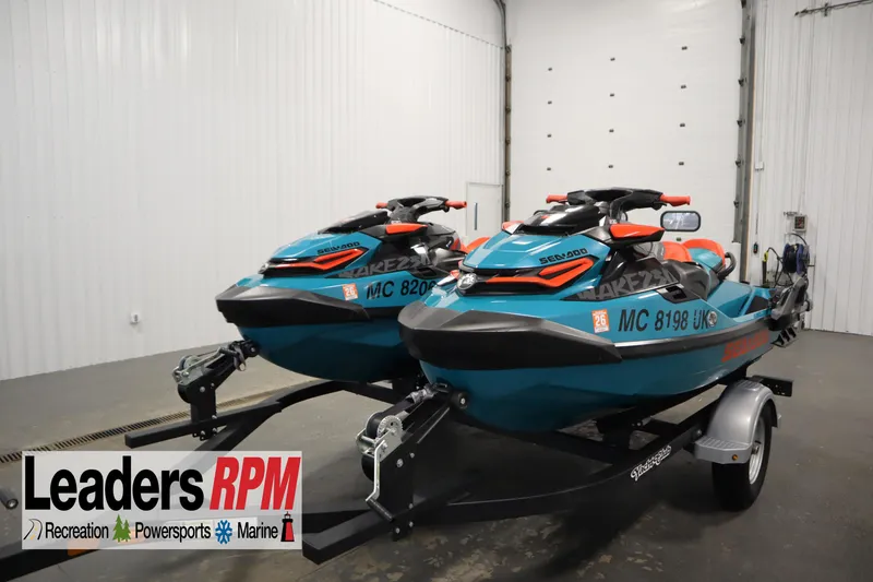 The Image of 2019 Sea-Doo Wake Pro 230 jet skis on trailer in indoor storage. - 1
