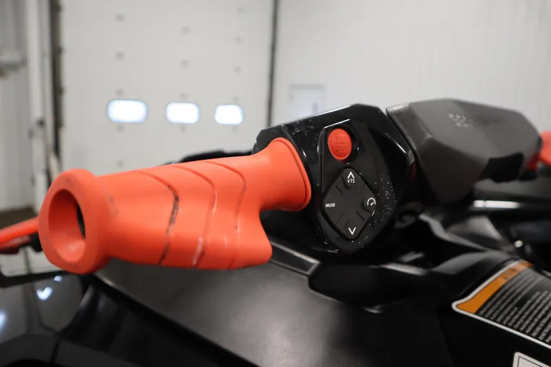 Slide: The Image of Close-up of 2019 Sea-Doo Wake Pro 230 handlebar controls in a garage setting. - 12