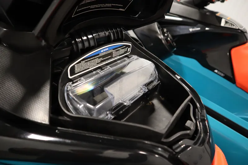 Slide: The Image of 2019 Sea-Doo Wake Pro 230 storage compartment with clear cover and instructions label. - 15