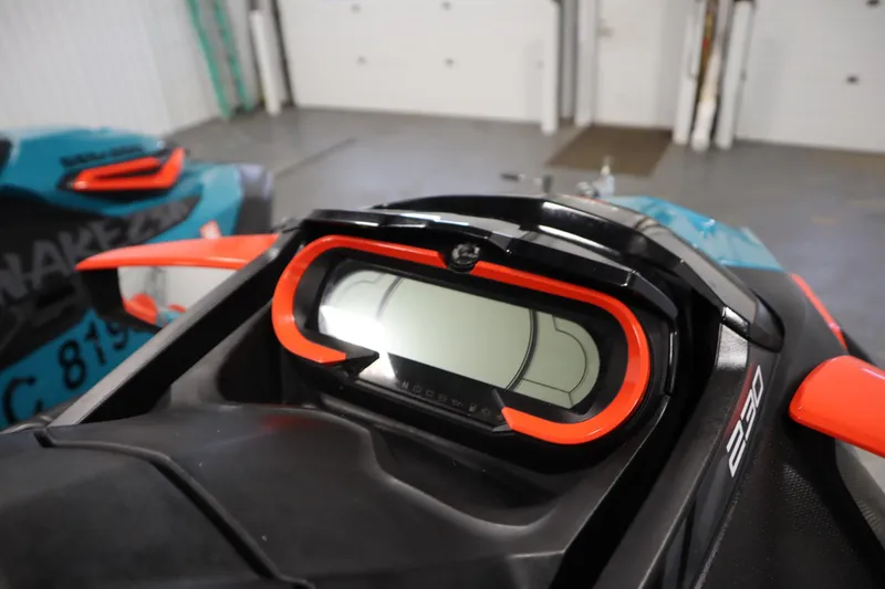 Slide: The Image of 2019 Sea-Doo Wake Pro 230 dashboard with vibrant red accents in a garage setting. - 24