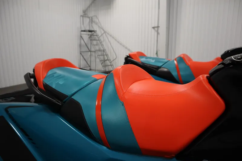 Slide: The Image of 2019 Sea-Doo Wake Pro 230 with vibrant orange and teal seating in a storage area. - 28