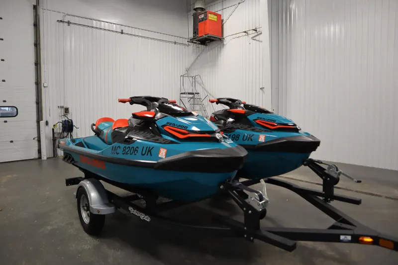 Slide: The Image of 2019 Sea-Doo Wake Pro 230 jet skis on trailer in garage setting. - 3