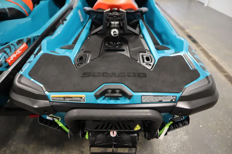Slide: The Image of 2019 Sea-Doo Wake Pro 230 jet ski, rear view, showcasing sleek design and vibrant colors. - 31
