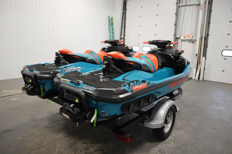 Slide: The Image of 2019 Sea-Doo Wake Pro 230 jet skis on trailer in garage setting. - 5