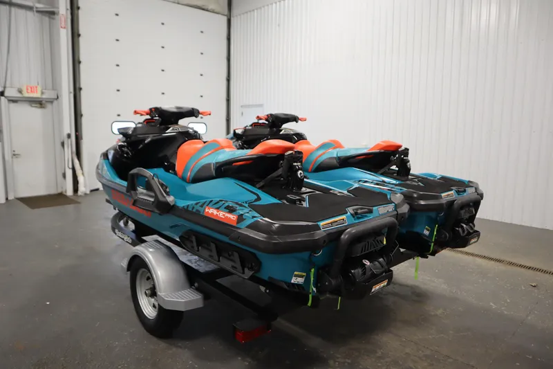 Slide: The Image of 2019 Sea-Doo Wake Pro 230 jet skis on trailer in indoor garage setting. - 7