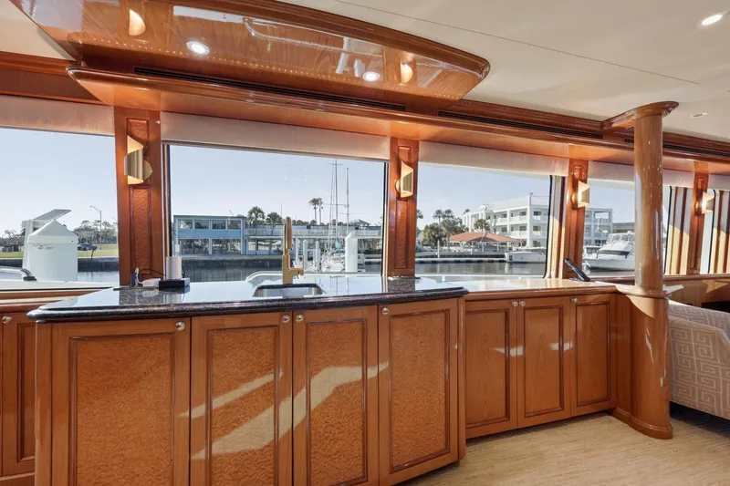 Slide: The Image of Luxurious interior of 2008 Cheoy Lee 95 Motor Yacht with elegant wood cabinetry and waterfront view. - 35
