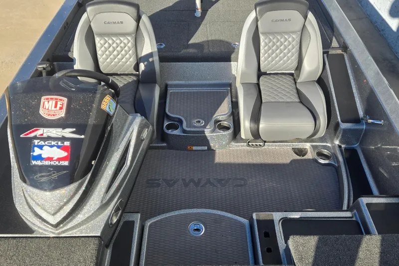 Slide: The Image of 2023 Caymas CX 18 SS boat interior with dual seats and branded console. - 10