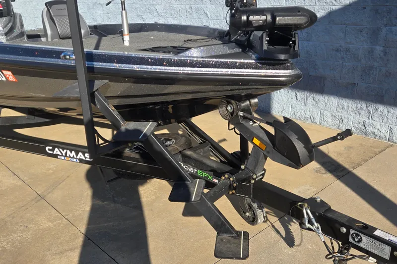 Slide: The Image of 2023 Caymas CX 18 SS boat on trailer, parked on concrete surface. - 4