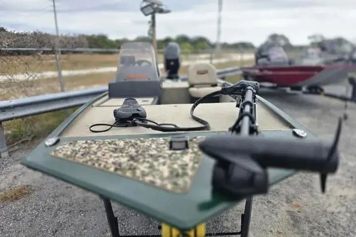 Slide: The Image of 2025 Bass Tracker III Classic boat with trolling motor on a trailer. - 14