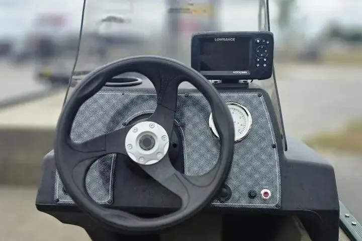 Slide: The Image of Steering console of 2025 Bass Tracker III Classic boat with navigation display. - 16