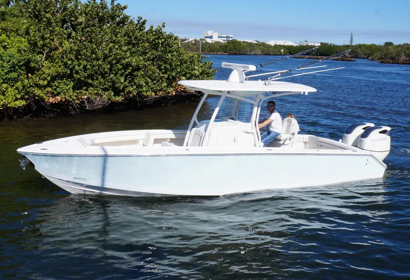 The Image of 2015 Jupiter 30 FS boat cruising on a calm river near lush greenery. - 0