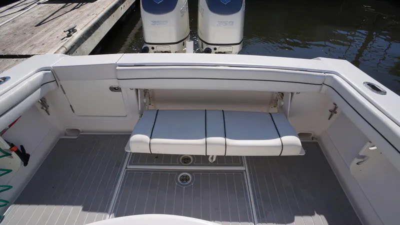Slide: The Image of 2015 Jupiter 30 FS boat with foldable seating and twin engines at dock. - 11