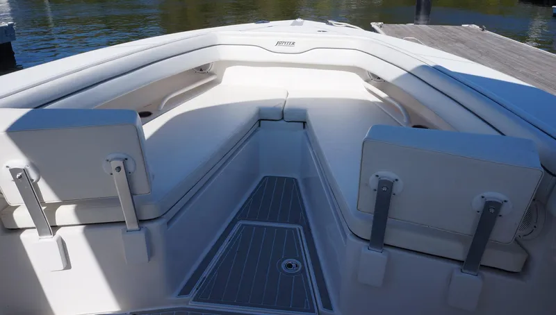 Slide: The Image of 2015 Jupiter 30 FS boat interior with cushioned seating and deck view. - 14