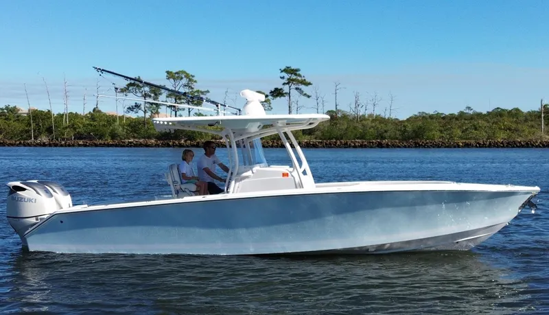 Slide: The Image of 2015 Jupiter 30 FS boat cruising on a calm river with two passengers. - 3