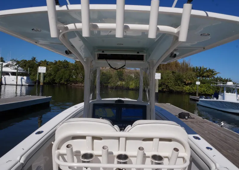 Slide: The Image of 2015 Jupiter 30 FS boat at dock, featuring helm and seating area. - 6