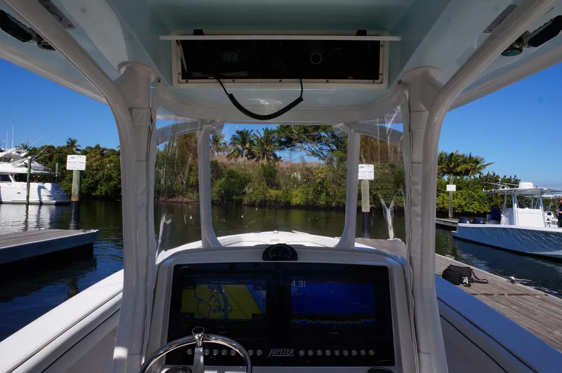 Slide: The Image of Interior view of 2015 Jupiter 30 FS boat with navigation system at marina. - 8