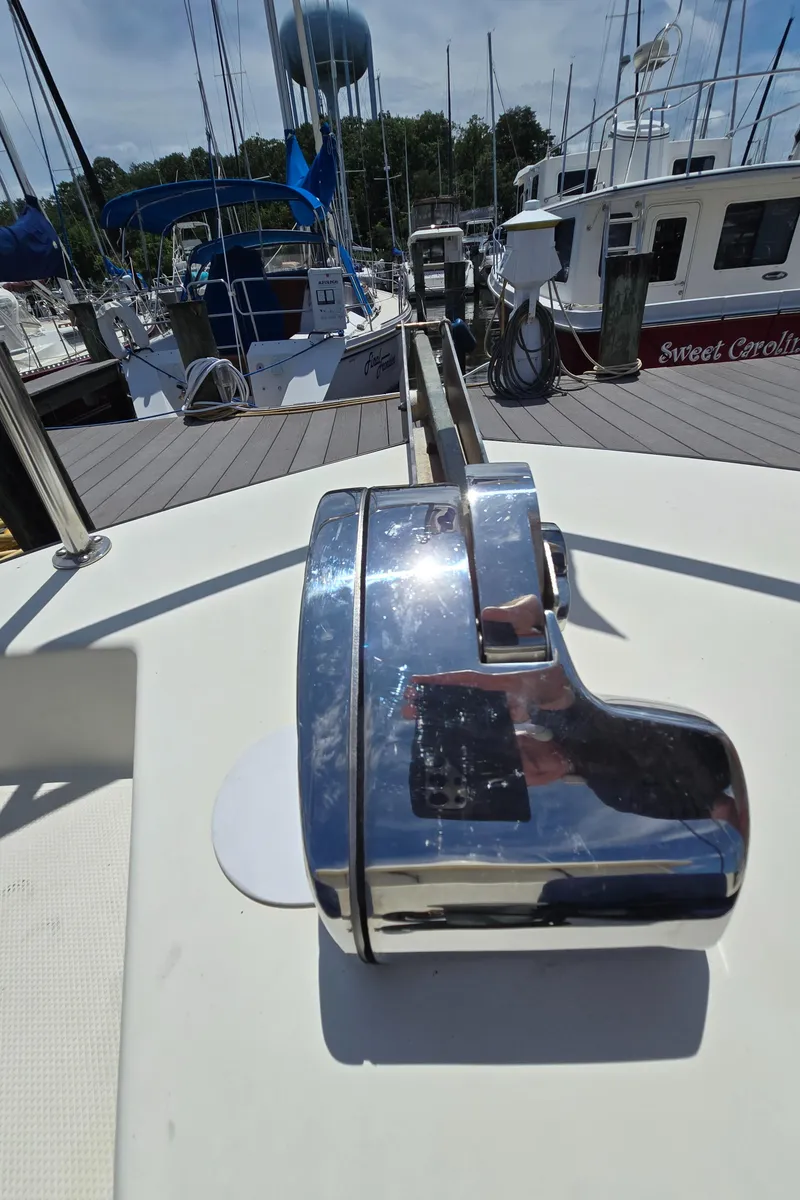 Slide: The Image of Nordic Tug 32 (2001) deck with chrome winch, docked at marina. - 35