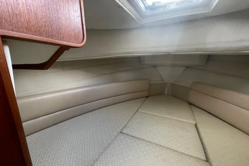 Slide: The Image of 2012 Ranger Tugs R-27 cabin interior with beige upholstery and wooden accents. - 18