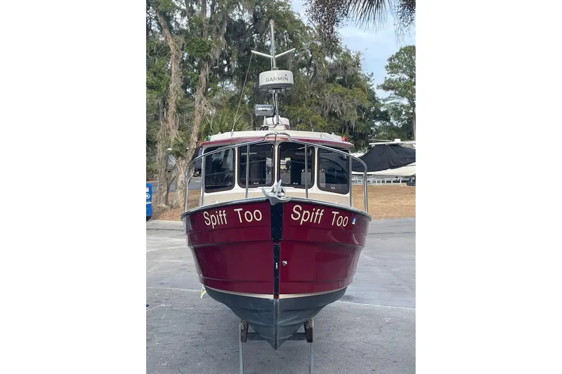 Slide: The Image of 2012 Ranger Tugs R-27 boat named "Spiff Too" on land, front view. - 5