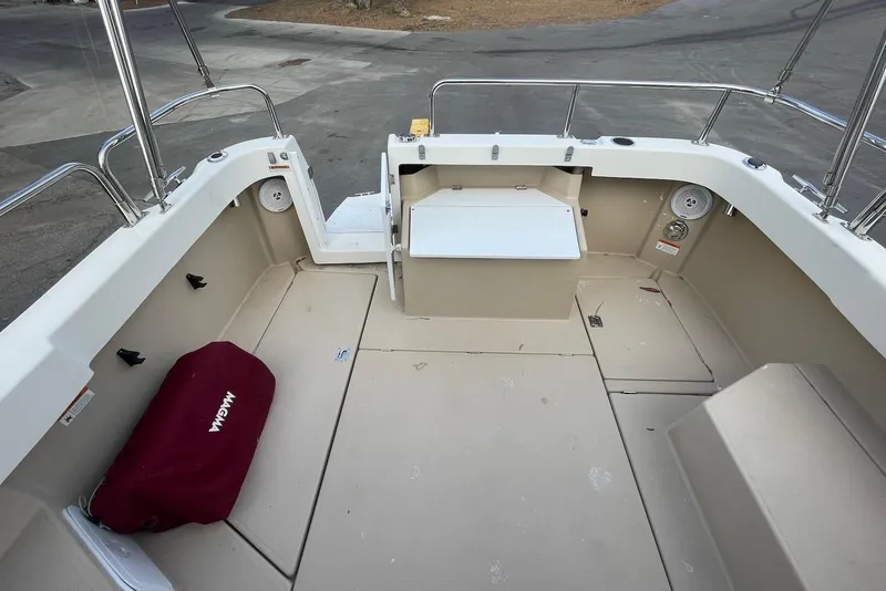 Slide: The Image of 2012 Ranger Tugs R-27 boat deck with seating and storage compartments. - 6
