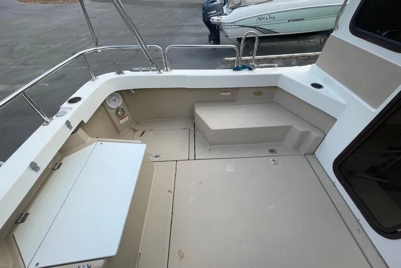 Slide: The Image of 2012 Ranger Tugs R-27 boat deck with seating and storage compartments. - 7