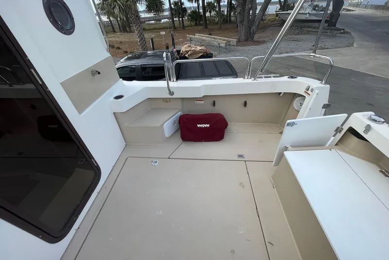 Slide: The Image of 2012 Ranger Tugs R-27 boat deck with seating and storage compartments. - 8